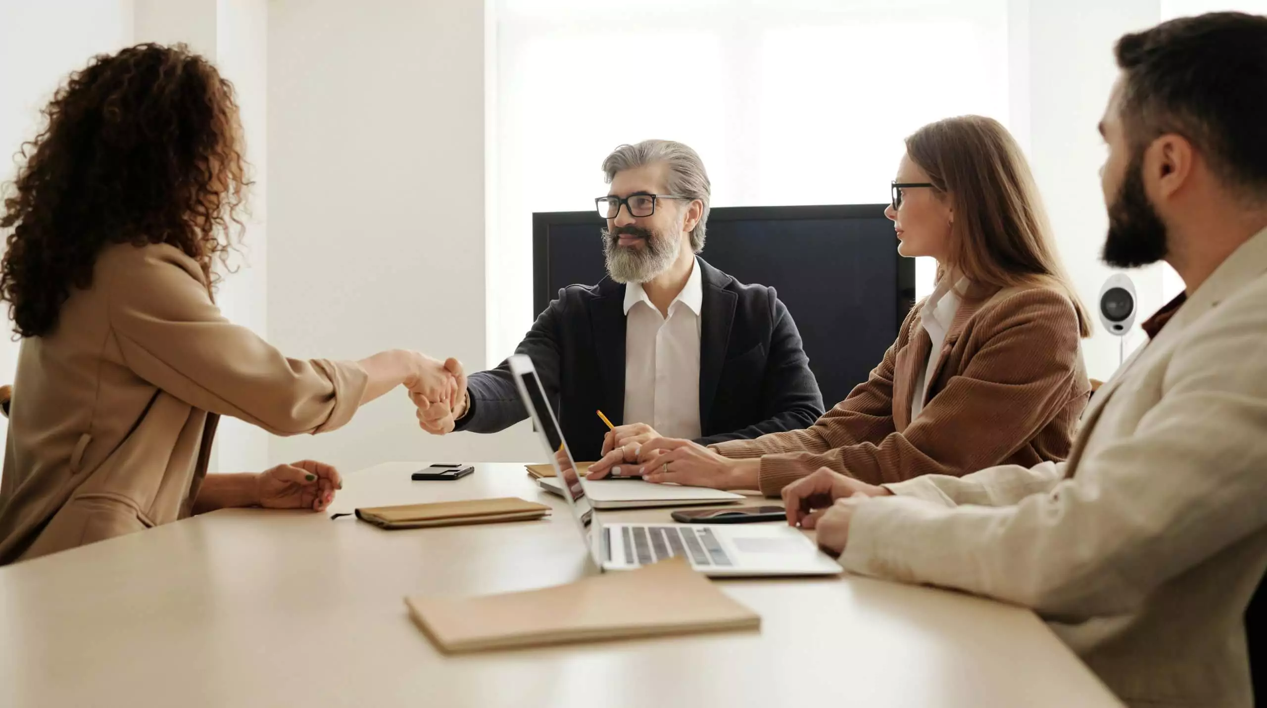 Consultants working together at a shared desk in the Dubai office