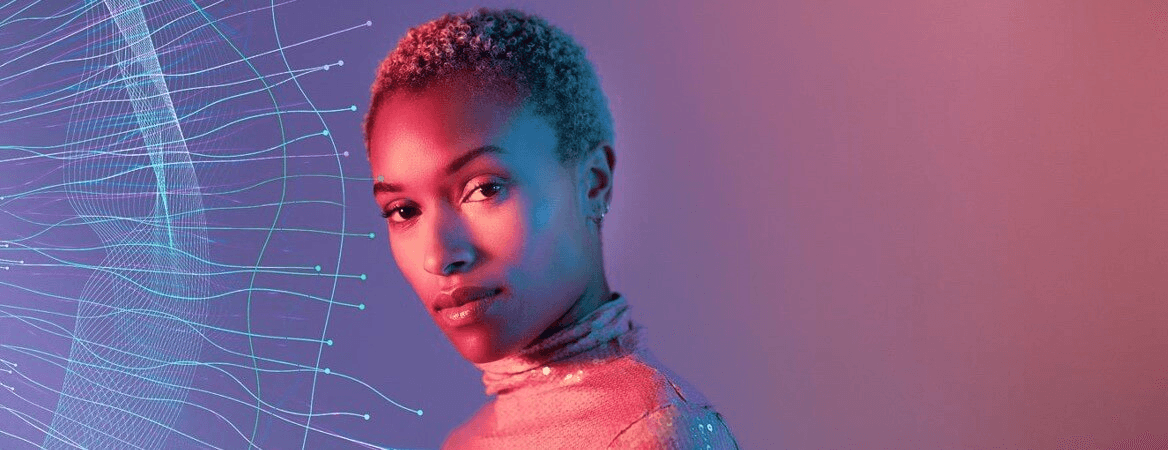 Portrait of a woman lit in pink and blue beside a flowing network of data lines