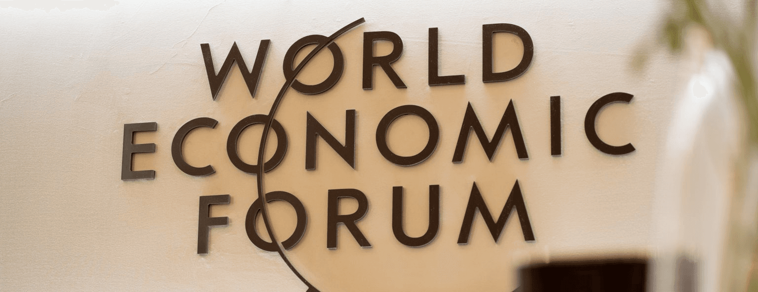 World Economic Forum lettering mounted on a wall at the meeting venue
